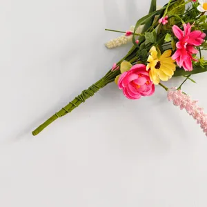 Close-up detail of colorful artificial wildflower bouquet with green stems for home decor.