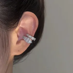 Detailed close-up of an elegant snake-shaped ear cuff with sparkling full diamond design