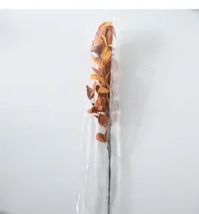 Artificial autumn eucalyptus and willow leaf branch bundle in orange tones for decor.