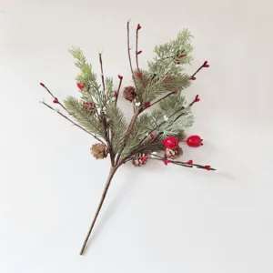 Detailed view of artificial Christmas pine branch with red berries and pine cones
