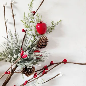 Artificial pine needle branch with red berries and pine cones for Christmas decor