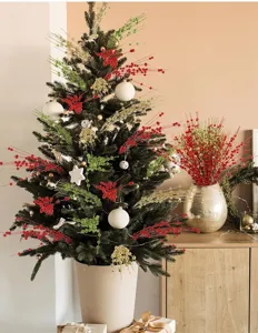 Detailed view of red, green and gold glitter berry stems decorating a Christmas tree.