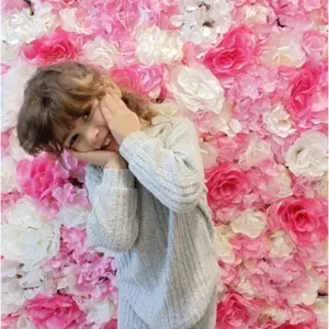 Pink and white artificial rose flower wall for wedding and event backdrop decoration.