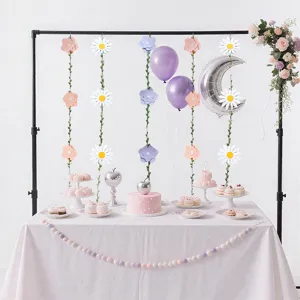 Pastel party decoration set with daisy flower garlands and paper pom pom banners