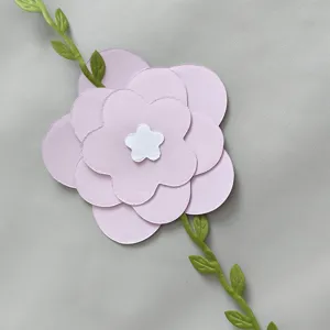 Detail of multi-layered lavender paper flower with green leaf vine for party decor