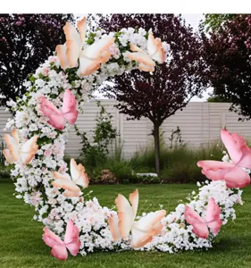 Large gradient PE artificial butterflies decorating a white floral moon arch in garden