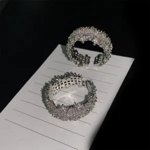 Detailed view of sparkling silver open rings with full cubic zirconia stones.