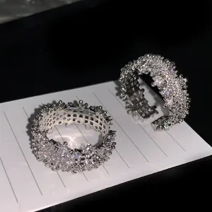 Detailed macro view of luxury full zircon open rings featuring high-sparkle textured surface