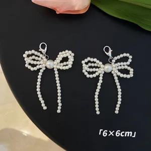 Exquisite pair of white pearl bow charms with lobster clasps for shoes and bags, 6x6cm size