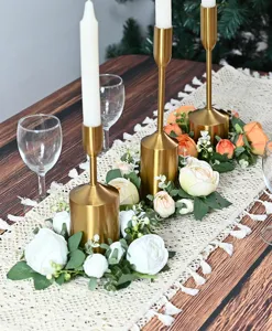 Detailed view of elegant artificial peony candle wreaths for festive dinner table decor