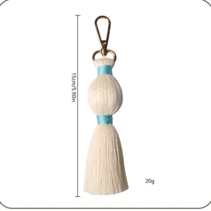 Handmade cotton tassel keychain and bag charm with metal clasp, 15cm length, lightweight.