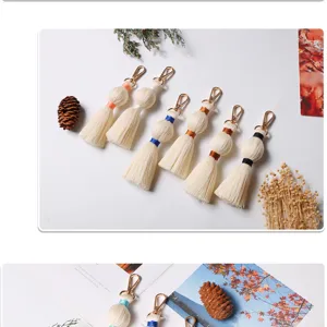 Handmade cotton woven tassel keychain bag pendant, vintage style beige cotton rope accessory.