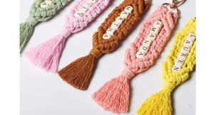 Macro view of handmade bohemian macrame keychains with personalized wooden letter beads
