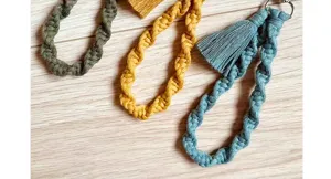 Close-up detail shot of handmade woven cotton macrame keychain wristlet with chic tassel.