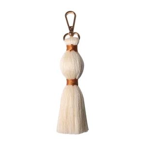 Handmade woven cotton tassel keychain bag charm, cute boho accessory for women and girls.