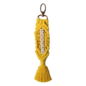 Handmade yellow macrame keychain with LAUREN wooden letter beads and boho tassel charm