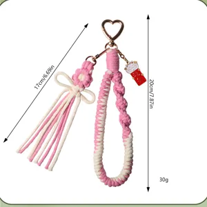 Handmade pink braided cotton keychain with flower and bow, detail view with size info