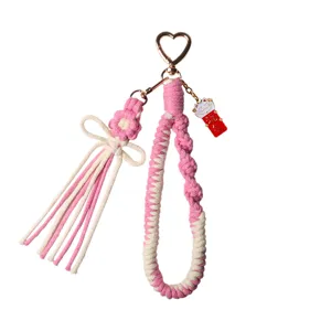 Handmade pink woven daisy flower keychain with heart clasp and lucky cat charm accessory