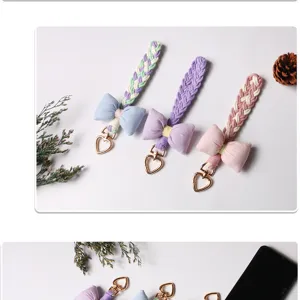 Detailed view of handmade braided phone lanyards with soft fabric bows