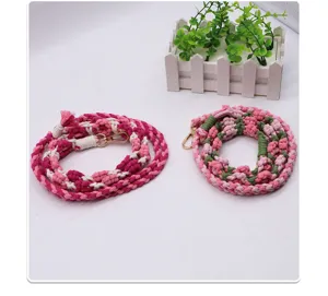Detail of hand-woven cotton rope bag straps with golden metal clasps in pink colors