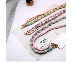 Detail view of colorful handmade woven cotton flower lanyards with metal lobster clasps