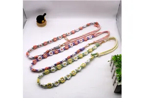 Detailed macro view of hand-woven cotton floral lanyards with durable golden metal clasps
