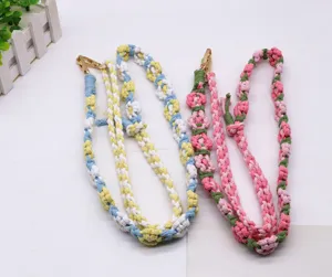 Detailed view of handmade woven cotton flower straps featuring elegant gold metal lobster clasps