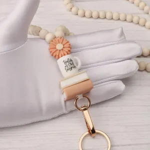 Wooden bead lanyard keychain with cute coffee cup and book charms for holding ID badge.