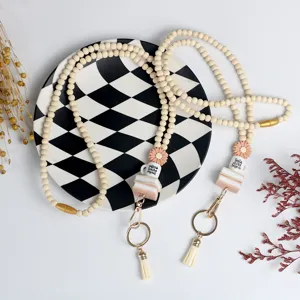 Detailed view of teacher wooden bead lanyard keychain featuring cute book and coffee charms.