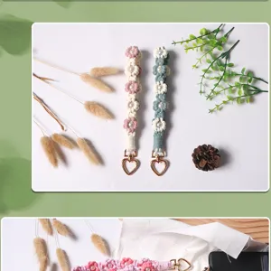 Detailed view of hand-woven daisy flower wrist straps with pearl centers and heart clasps