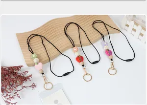 Teacher lanyard featuring wood beads, apple charm, and ID card holder detail view