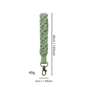 Handmade woven macrame wrist strap keychain in sage green with dimensions 20cm by 3cm