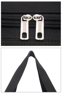 Gros plan sur les tireurs de fermeture éclair en métal et la poignée noire solide du sac de sport.