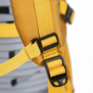 Close-up detail of an adjustable yellow backpack shoulder strap with black buckles