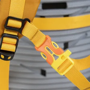 Close-up detail of hiking backpack orange and yellow buckle with durable mesh padding.
