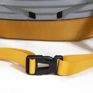 Close-up of yellow nylon strap with black durable plastic buckle on outdoor backpack