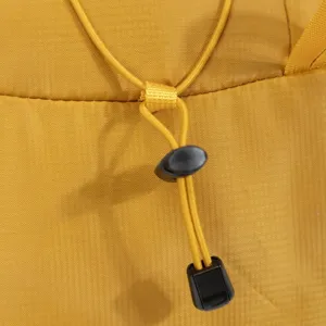 Macro view of adjustable yellow drawstring with black toggle on outdoor hiking backpack