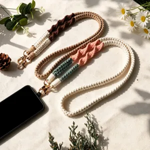 Woven macramé wrist phone lanyard straps in brown and teal colors with golden metal clips.