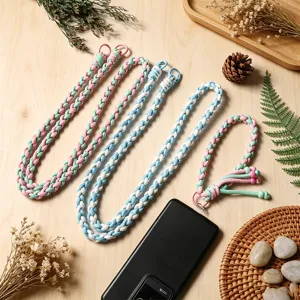 Hand-woven colorful cotton phone lanyard for crossbody neck carry on wood table setup