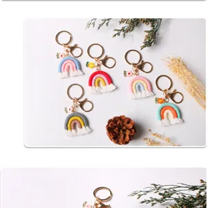 Set of colorful handmade crochet rainbow tassel keychains with flower charms and gold clips.