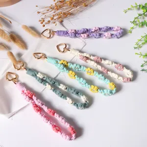 Handmade macramé wristlet phone strap with pearls and heart-shaped gold clasp