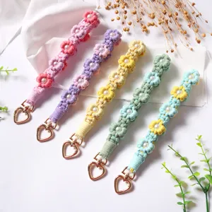 Handmade woven daisy flower wrist straps with pearls and heart-shaped metal clasps.