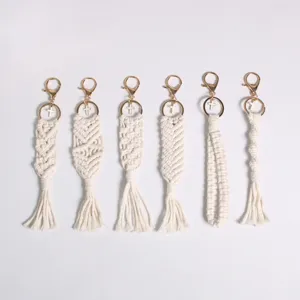 Set of six handmade cream macrame keychains with gold clasps and small cross charms