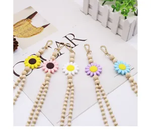 Handmade wooden bead lanyard featuring colorful silicone daisy flowers and a gold metal clasp
