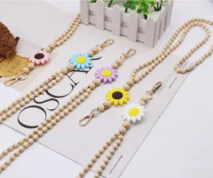 Handmade wooden bead lanyard detail featuring colorful silicone daisy charms