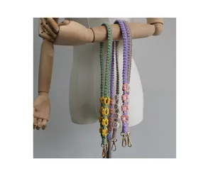 Hand-woven daisy pattern phone lanyards and bag straps in various pastel colors