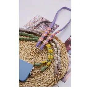 Detailed macro view of colorful woven daisy phone lanyards with double metal clasps