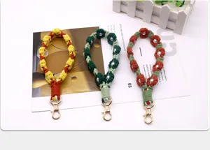 Handmade crochet flower phone wristbands with pearls in three vibrant color combinations