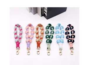 Handmade macramé floral wrist straps with pearl accents in six vibrant colors and gold clasps