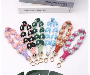 Handmade macrame flower wrist straps with pearls in various vibrant colors for keys